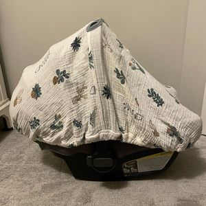 Little Unicorn infant car seat cover with magnetic buttons.